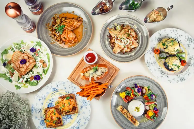 Pan Asian A top view of diverse gourmet dishes arranged on a white surface, showcasing culinary variety and elegance.